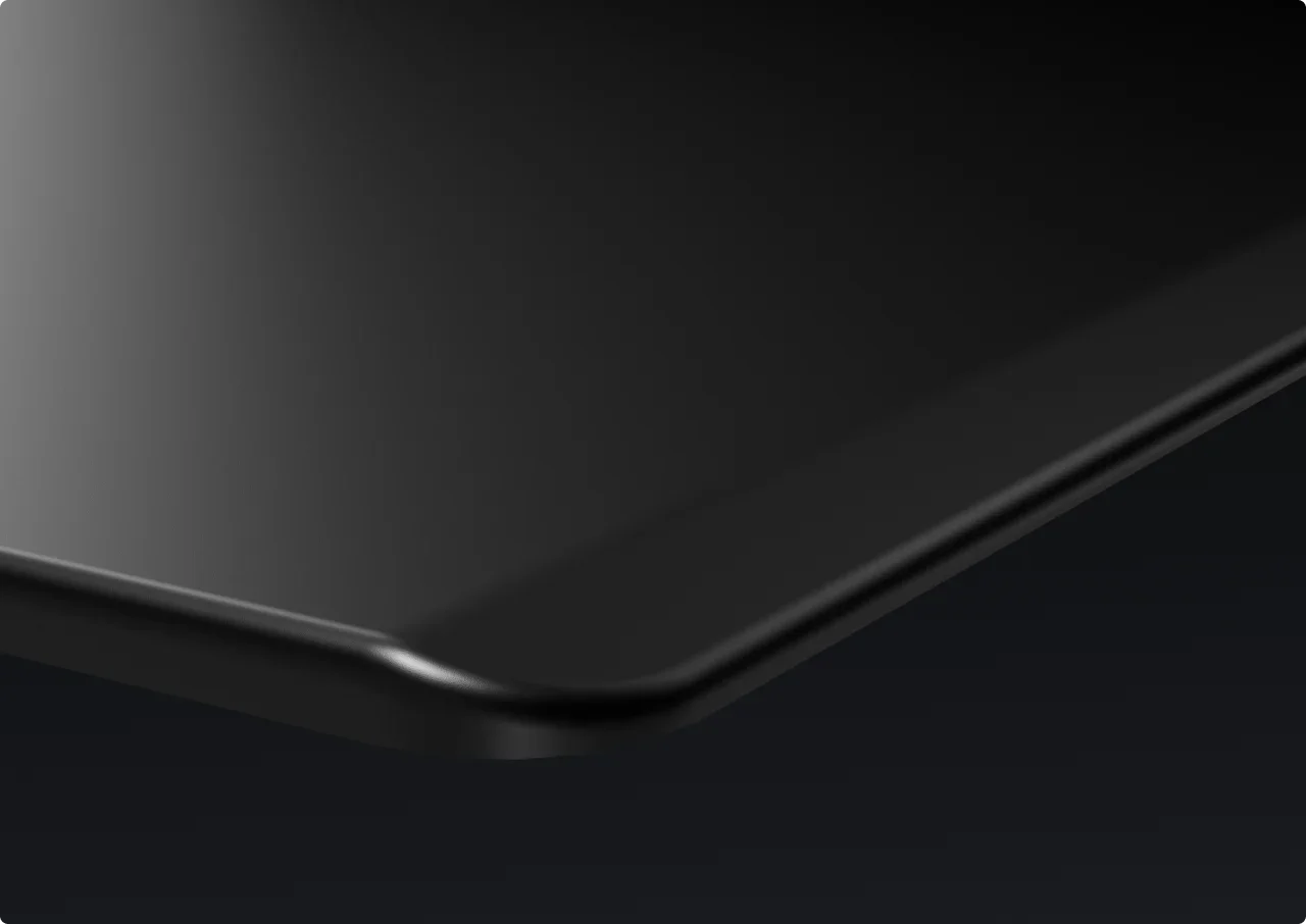 The black top's bevelled front edge on a dark background.