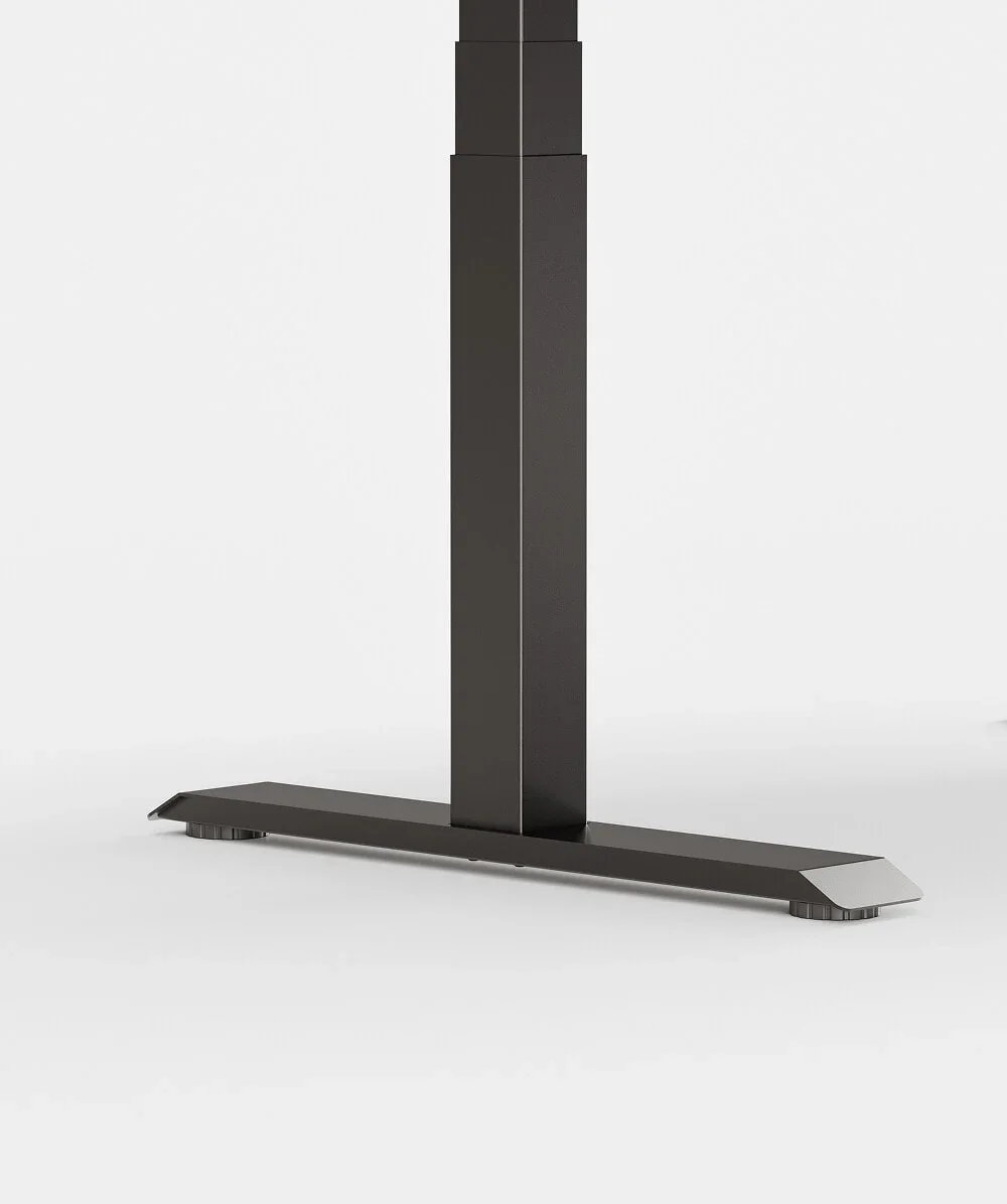 Studio close-up of a black leg column set toward the rear of its foot (C-shape), E7 Pro style, on pale grey.