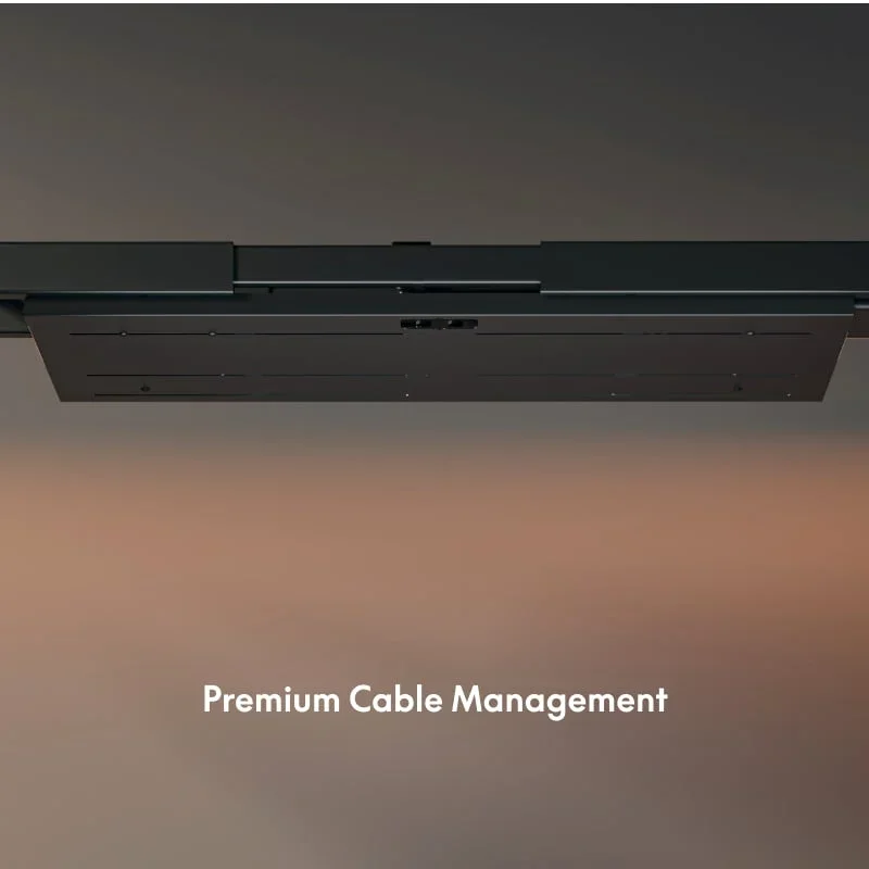 From below of the closed cable box mounted under a dark desktop, with a caption about cable management.
