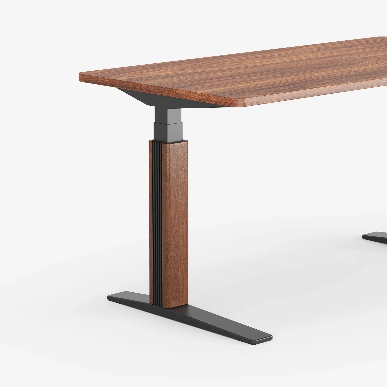 Three-quarter close-up of an E7 Pro leg with a walnut cover and black T-foot beneath a walnut desktop, on white.