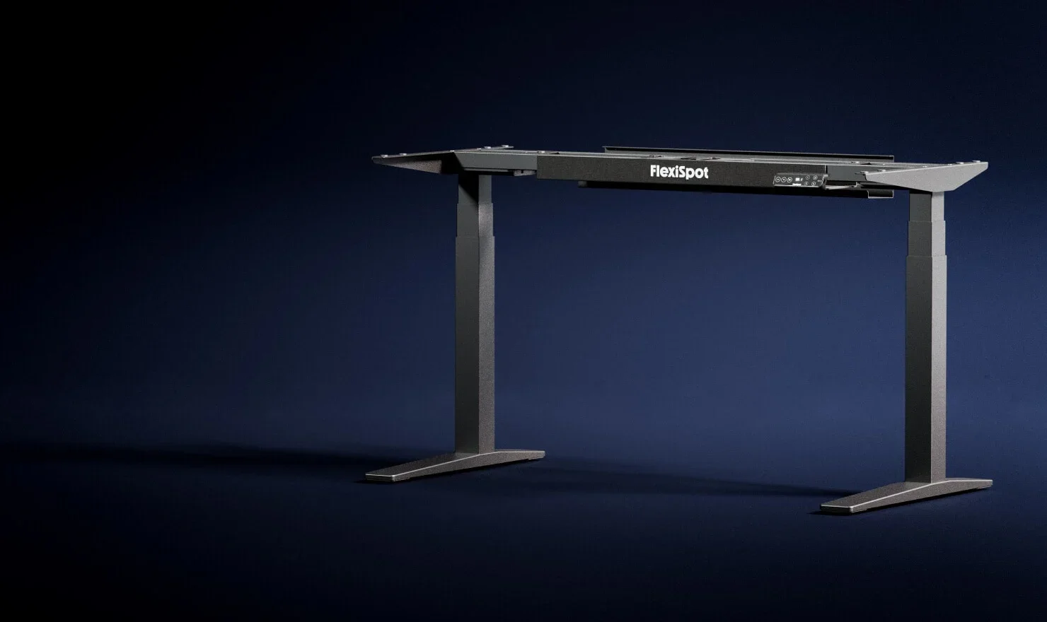 Wide dark navy studio shot of a black C-leg frame with FlexiSpot-branded crossbeam.