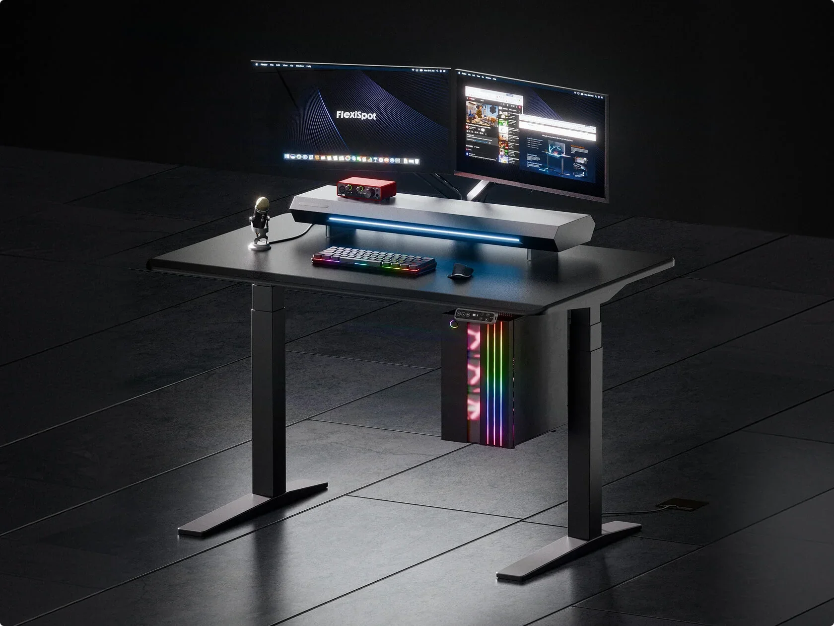 Dark studio render of the black desk with a monitor riser, two monitors, RGB keyboard and an RGB PC in an under-desk holder.