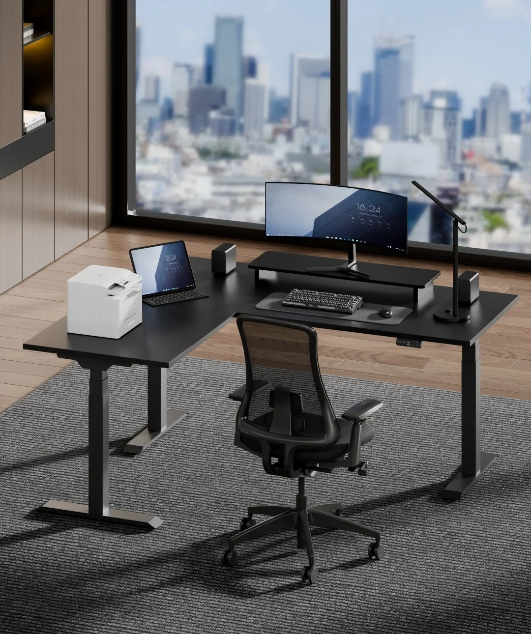 Black E7L corner desk with curved monitor, printer, tablet and mesh chair in a high-rise office overlooking a city skyline; no text.