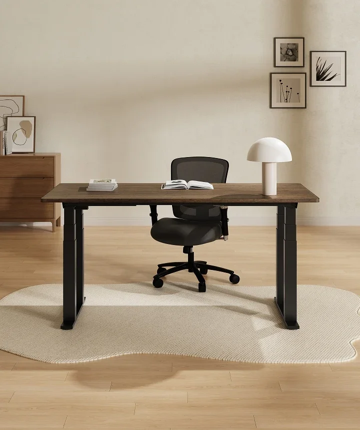 E7 Plus with a dark top and mesh chair on a rug in a warm room with framed prints.