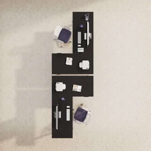 Top-down view of two black L-desks stacked end to end on beige carpet with purple chairs, monitors and desk props.