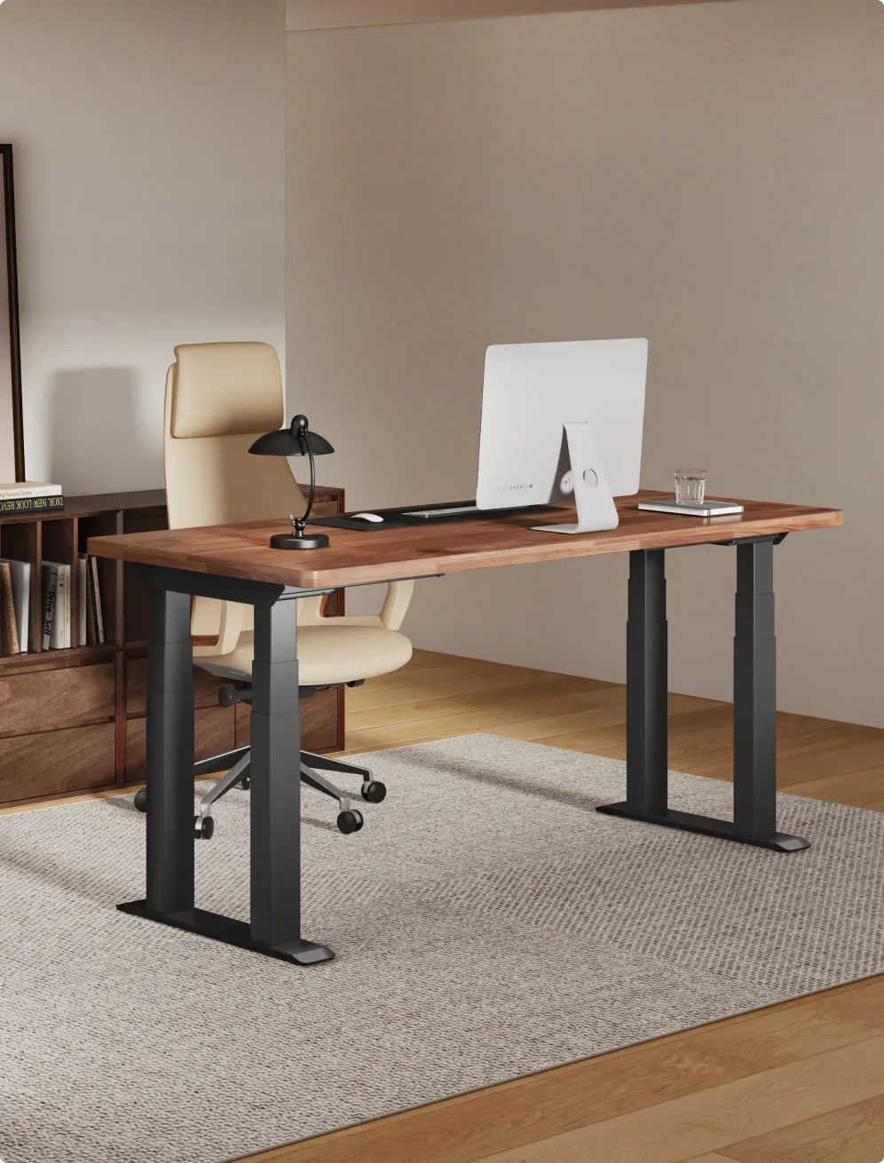 Portrait shot of a black four-leg frame with a solid walnut top, white all-in-one computer and cream leather chair in a calm taupe study with a walnut sideboard and grey rug.