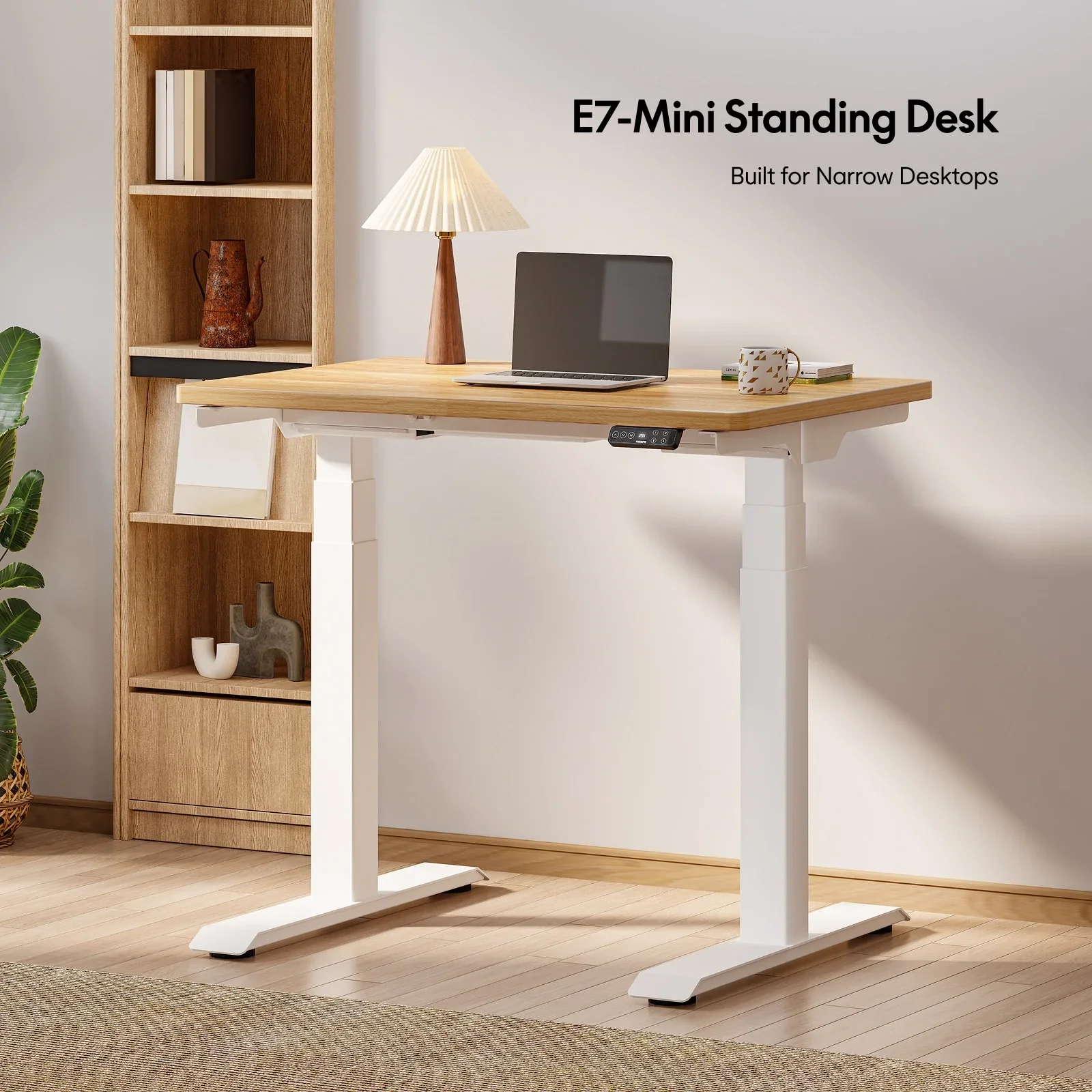 White-frame E7 Mini with a light oak top, laptop and pleated lamp in a room with a wooden shelf and plant, with product-name title text at top right.