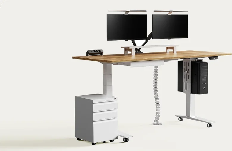 White-frame desk with walnut-look top, dual monitors on arms, monitor riser, CPU holder, cable spine and white pedestal on a plain background.