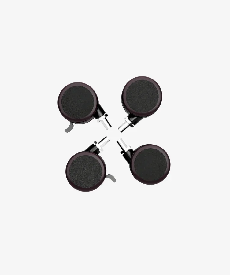 Top-down studio shot of four black locking casters on a near-white background.